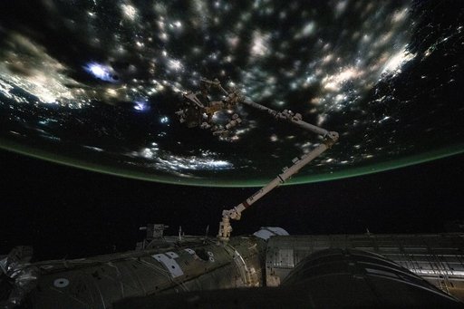 City lights beneath the clouds highlight the North China Plain near the Yellow Sea