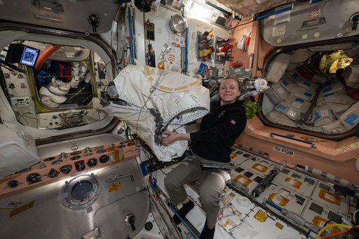 NASA astronaut Zena Cardman unpacking new hardware from the Cygnus XL