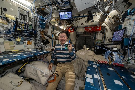 JAXA astronautKimiya Yui smiles for a portrait during weekend housecleaning activities