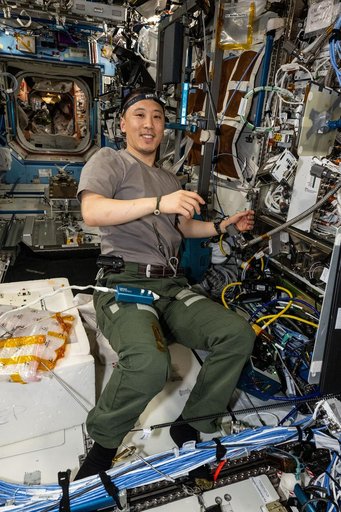 NASA astronaut Jonny Kim replaces computer hardware inside the Cold Atom Lab