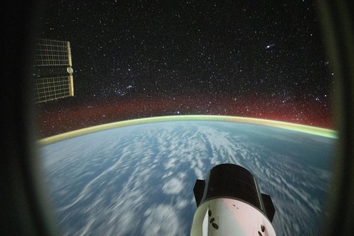 Clouds stretch into a soft blur and a bright airglow blankets Earth’s horizon
