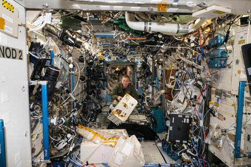 NASA astronaut Zena Cardman transfers the Advanced Space Experiment Processor-2