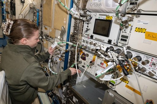 NASA astronaut Zena Cardman installs the Advanced Space Experiment Processor-2