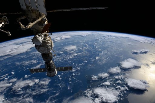 The Soyuz MS-27 crew spacecraft  above a gleaming blue Atlantic Ocean