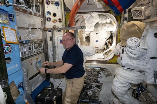 NASA astronaut Mike Fincke performs maintenance tasks inside the Quest airlock