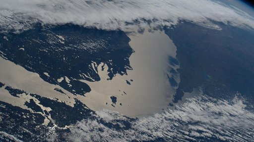 Lake Michigan beams in the afternoon sunlight as clouds blanket its southern tip