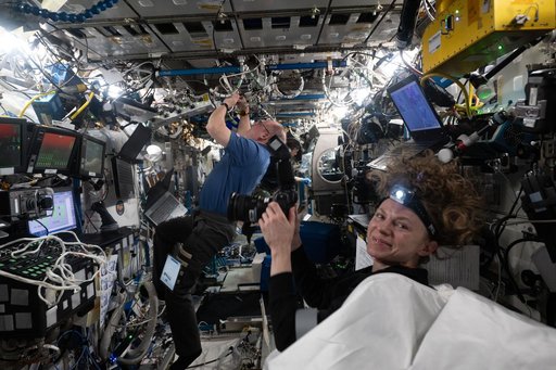 NASA astronaut Zena Cardman photographs NASA astronauts Mike Fincke and Jonny Kim