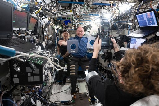 NASA astronaut Zena Cardman photographs NASA astronauts Mike Fincke and Jonny Kim