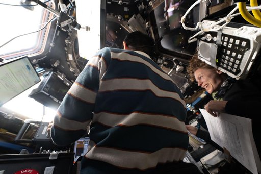 Astronauts Kimiya Yui and Zena Cardman train inside the cupola to use the Canadarm2 robotic arm
