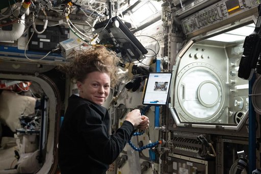 NASA astronaut Zena Cardman installs research hardware inside the Microgravity Science Glovebox