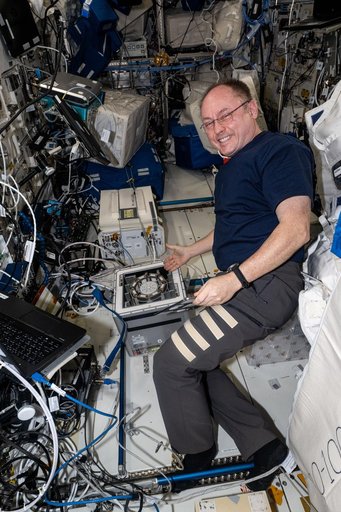 NASA astronaut Mike Fincke works on a Kubik research incubator