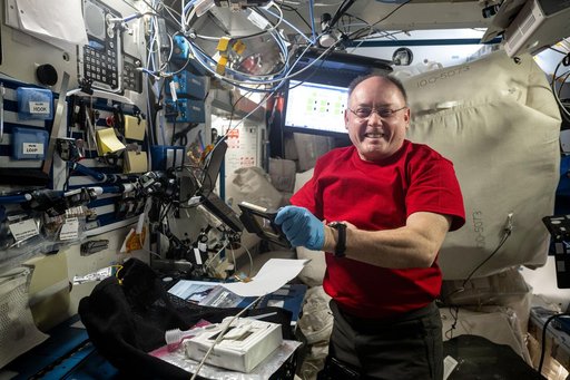NASA astronaut Mike Fincke smiles for a portrait while organizing cargo