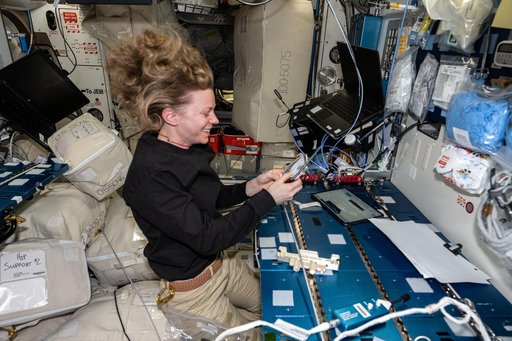 NASA astronaut Zena Cardman performs maintenance on the Multi-use Variable-g Platform-02