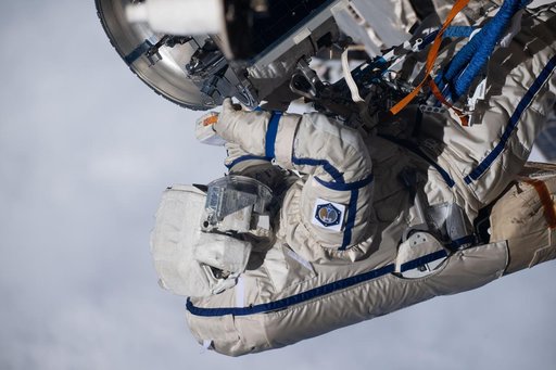 Cosmonaut Alexey Zubritsky is pictured in his Orlan spacesuit conducting a spacewalk