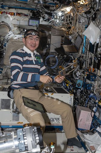 JAXA astronaut Kimiya Yui assembles and installs carbon dioxide removal gear
