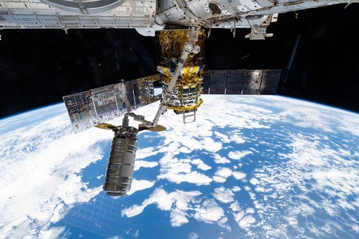 The Cygnus XL cargo craft is pictured in the grips of the Canadarm2 robotic arm