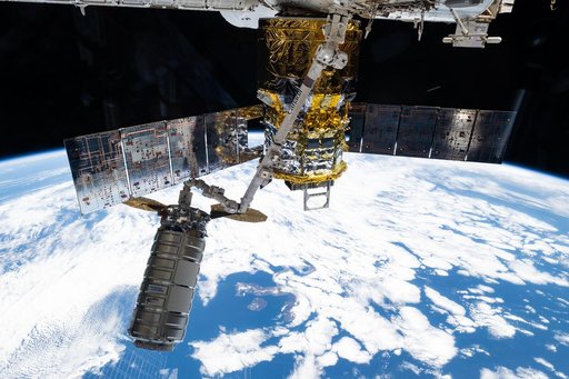 The Cygnus XL cargo craft is pictured in the grips of the Canadarm2 robotic arm