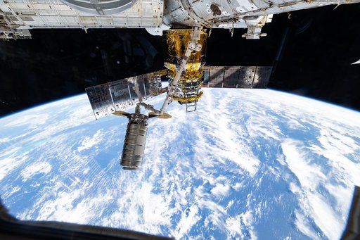 The Cygnus XL cargo craft is pictured in the grips of the Canadarm2 robotic arm