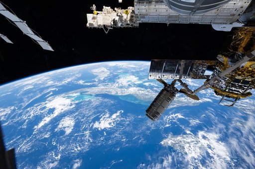 The Cygnus XL cargo craft is pictured in the grips of the Canadarm2 robotic arm
