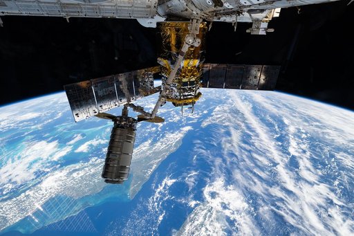 The Cygnus XL cargo craft is pictured in the grips of the Canadarm2 robotic arm