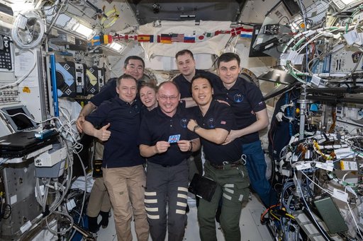 The seven-member Expedition 73 crew gathers together for a portrait