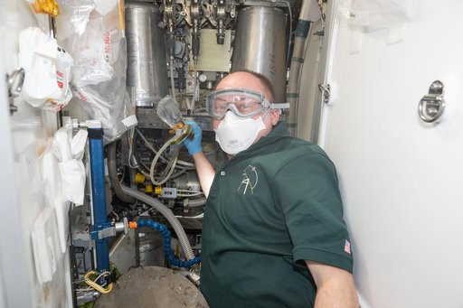 NASA astronaut Mike Fincke wears personal protective equipment inside the Tranquility module