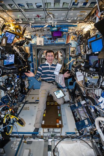 JAXA astronaut Kimiya Yui appears to juggle research hardware