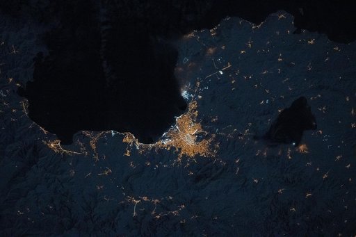 The city lights of Van, Türkiye, and its suburbs and villages, dot the southeast coast of Lake Van