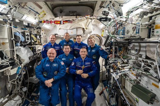 The seven-member Expedition 74 crew gathers for a crew portrait