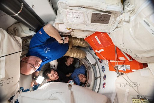 NASA's SpaceX Crew-11 members pose for a portrait before entering the SpaceX Dragon