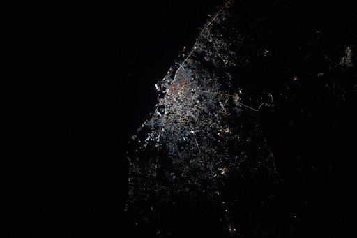 Benghazi, Libya, shines with bright, modern city lights on the Mediterranean coastline