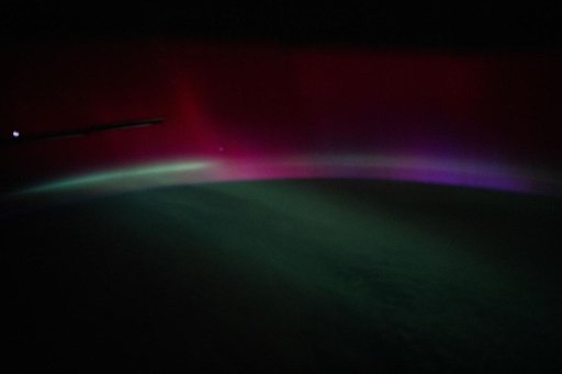 A wispy, multi-colored aurora created by a geomagnetic storm