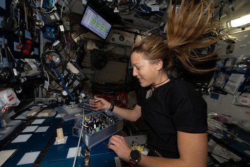 ESA astronaut Sophie Adenot installs research components inside the Advanced Space Experiment Processor‑2