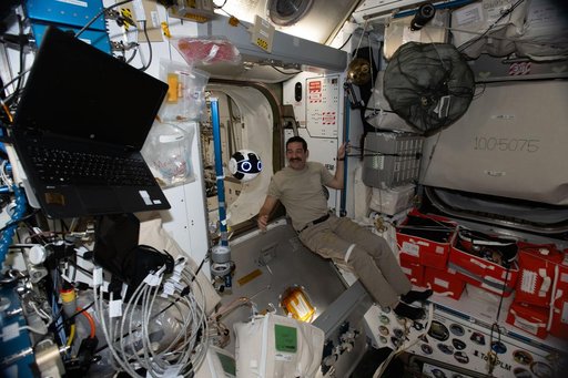 NASA astronaut Jack Hathaway monitors a free‑flying robotic camera