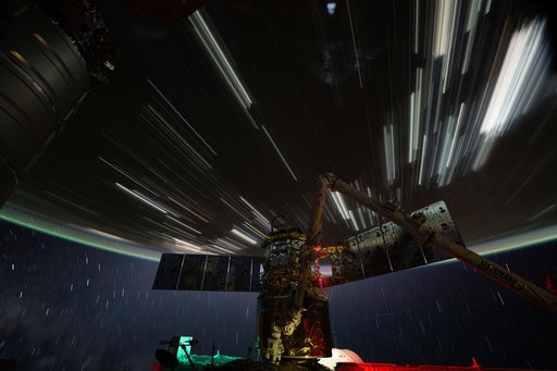 Star trails and city lights streak above the China–Mongolia border