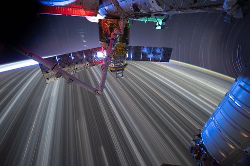 Star trails and city lights streak as the International Space Station orbits Earth
