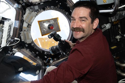 NASA astronaut Jack Hathaway smiles for a portrait inside the International Space Station’s cupola