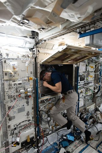 NASA astronaut Chris Williams configures advanced robotics hardware