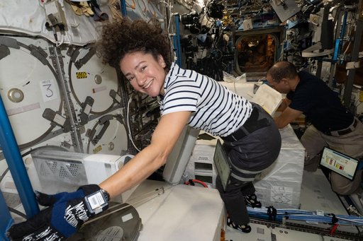 NASA astronauts Jessica Meir and Chris Williams collect frozen research samples