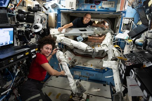 NASA astronauts Jessica Meir and Chris Williams familiarize themselves with spacewalking hardware