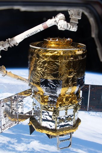 The HTV‑X1 cargo spacecraft is in the grasp of the Canadarm2 robotic arm
