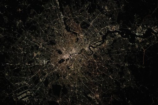 London, England, is split by the River Thames in this nighttime photograph