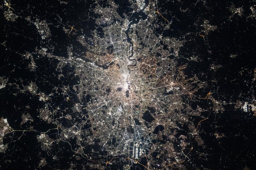 London, England, is split by the River Thames in this nighttime photograph