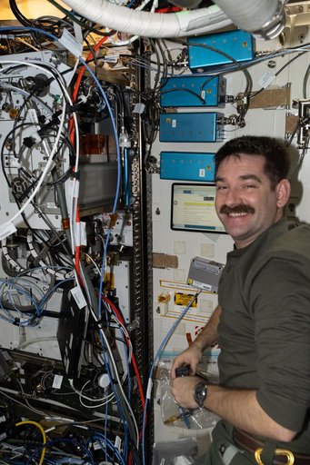 NASA astronaut Jack Hathaway checks the operation of the Exploration Potable Water Dispenser