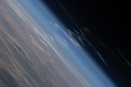 The exhaust plume left behind by Artemis II is pictured from the International Space Station