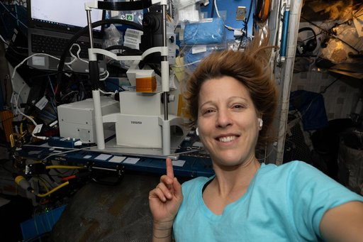 ESA astronaut Sophie Adenot shows off the Optical Coherence Tomography machine