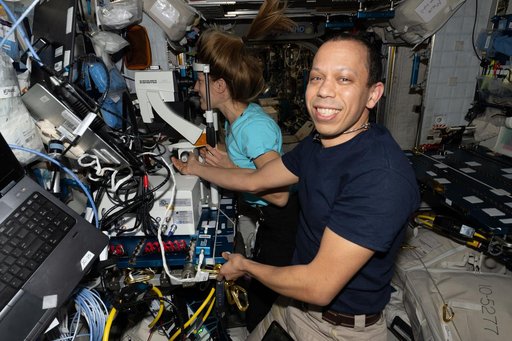 NASA astronaut Chris Williams guides ESA astronaut Sophie Adenot during an eye exam