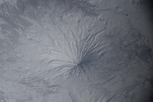 The snow‑covered Kronotsky, a major stratovolcano on the Kamchatka Peninsula in Russia