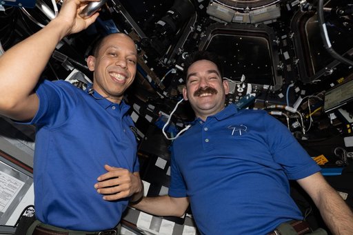 NASA astronauts Chris Williams and Jack Hathaway pose for a portrait inside the cupola