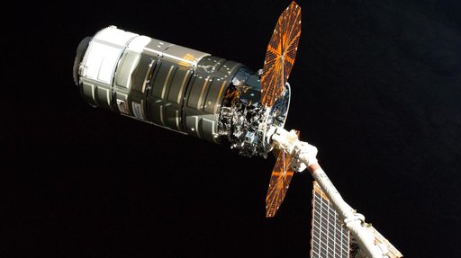 The Cygnus XL cargo spacecraft is pictured in the grips of the Canadarm2 robotic arm